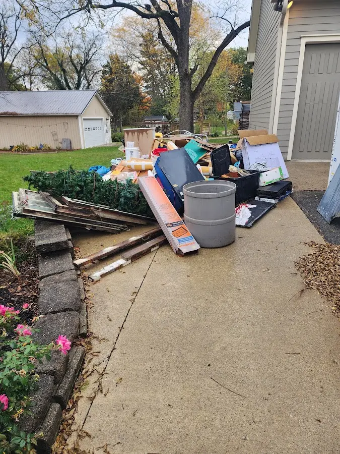 Dumpster being loaded with debris for Estate Cleanout Dumpster Rental in Granger
